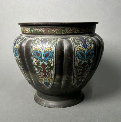 a silver vase with a multicolored design on it