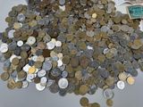 a pile of coins sitting on top of a table next to a pile of money