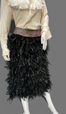 an image of a mannequin dressed in black feathers and a white blouse