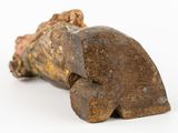 a small statue of a man laying on a rock