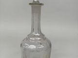 a clear glass bottle with a diamond on the top of it