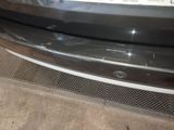 a close up of a car bumper with a number plate on it