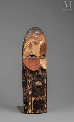 a wooden mask with a face and a long nose