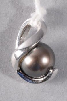 a silver ring with a brown pearl on it