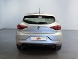 the rear end of a silver car in a white room