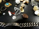 a black table topped with lots of jewelry on it