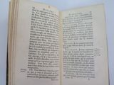 an open book on a table with a white background