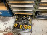 un tiroir rempli de vis et d'autres outils dans un garage