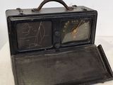 une radio à l'ancienne posée sur une table blanche