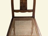 a wooden chair with a cane back and a cane seat