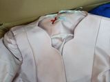 a pink jacket in a box with a blue shirt in it