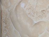 a stone relief of a woman holding a baby