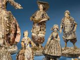 many figurines of people that are standing together