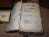 an old book sitting on the floor next to a box