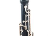 a close up of a black and silver clarinet