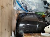 a wooden box filled with assorted items on the floor