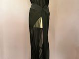the back of a black dress with sheer panels on a mannequin