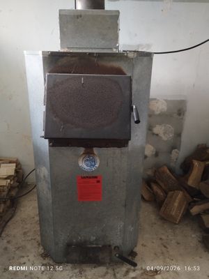 a small machine that is sitting in the middle of a pile of wood