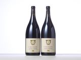 two bottles of wine sitting on top of a table