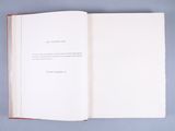 an open book sitting on top of a blue surface