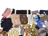 a pile of assorted clothing and accessories on a white surface
