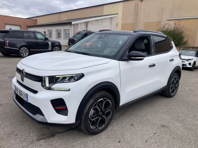 a white suv parked in a parking lot next to a building