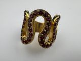 a close up of a gold ring with garnets on it
