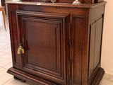 a wooden cabinet with a mirror on top of it