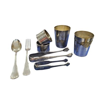 a lot of silverware and spoons on a white background