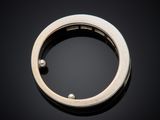 a close up of a silver ring on a black surface