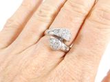 a woman ' s hand with a diamond ring on it