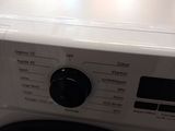 a white washer sitting on top of a dryer in a kitchen