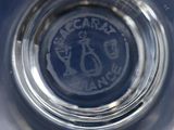 a close up of a glass of water with a logo on it