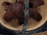 helmet of a soldier with a red cord around the vise