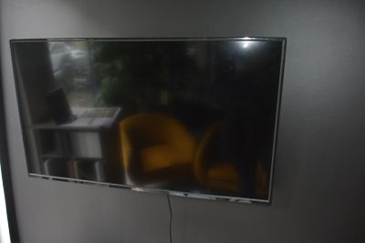 a flat screen tv hanging on the wall in a room