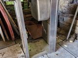 a sink in the middle of a room with a broken door