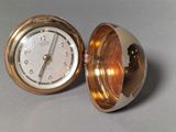 a clock that is sitting inside of a gold case
