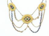 a gold necklace with a picture of a woman on it