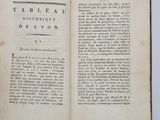 an open book on a white surface with a black and white title