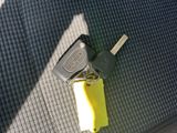 a yellow car key and a yellow keychain on the floor