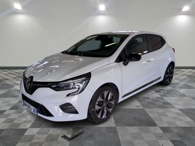 a white car is parked on a checkered floor in a garage
