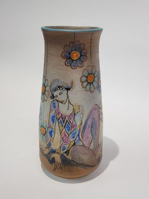 a vase that has a picture of a woman on it