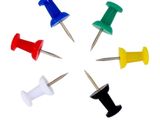 six punaises de couleurs différentes disposées en cercle sur un fond blanc