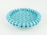 a close up of a small blue bowl on a white surface