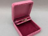 a small pink box with a ring inside of it