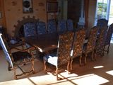 a large dining room table and chairs in the sun