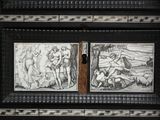 two paintings on the wall of a building with a wooden door