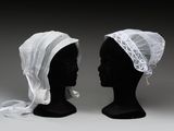 une paire de têtes de mannequins noires recouvertes de voiles blancs