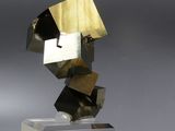 sculpture of a cube with a metal structure on top of it