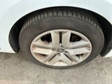 a close up of a tire on a white car